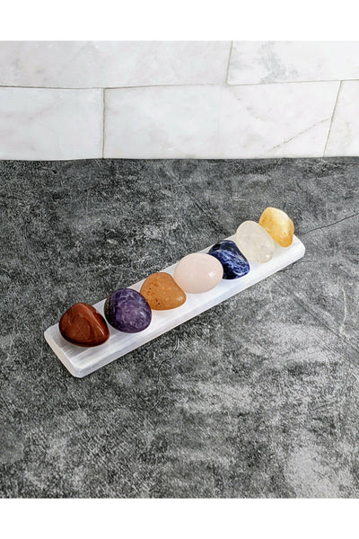 7 tumbled chakra crystals with a selenite charging tray