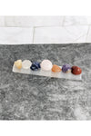 7 tumbled chakra crystals with a selenite charging tray